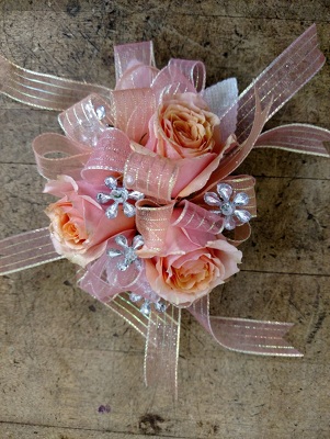 Coral roses corsage from Rose Garden Florist in Barnegat, NJ